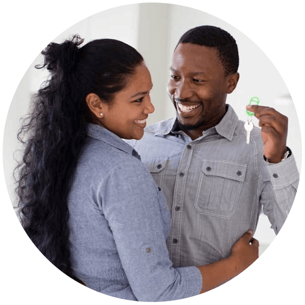 Man and woman holding up keys to a new home