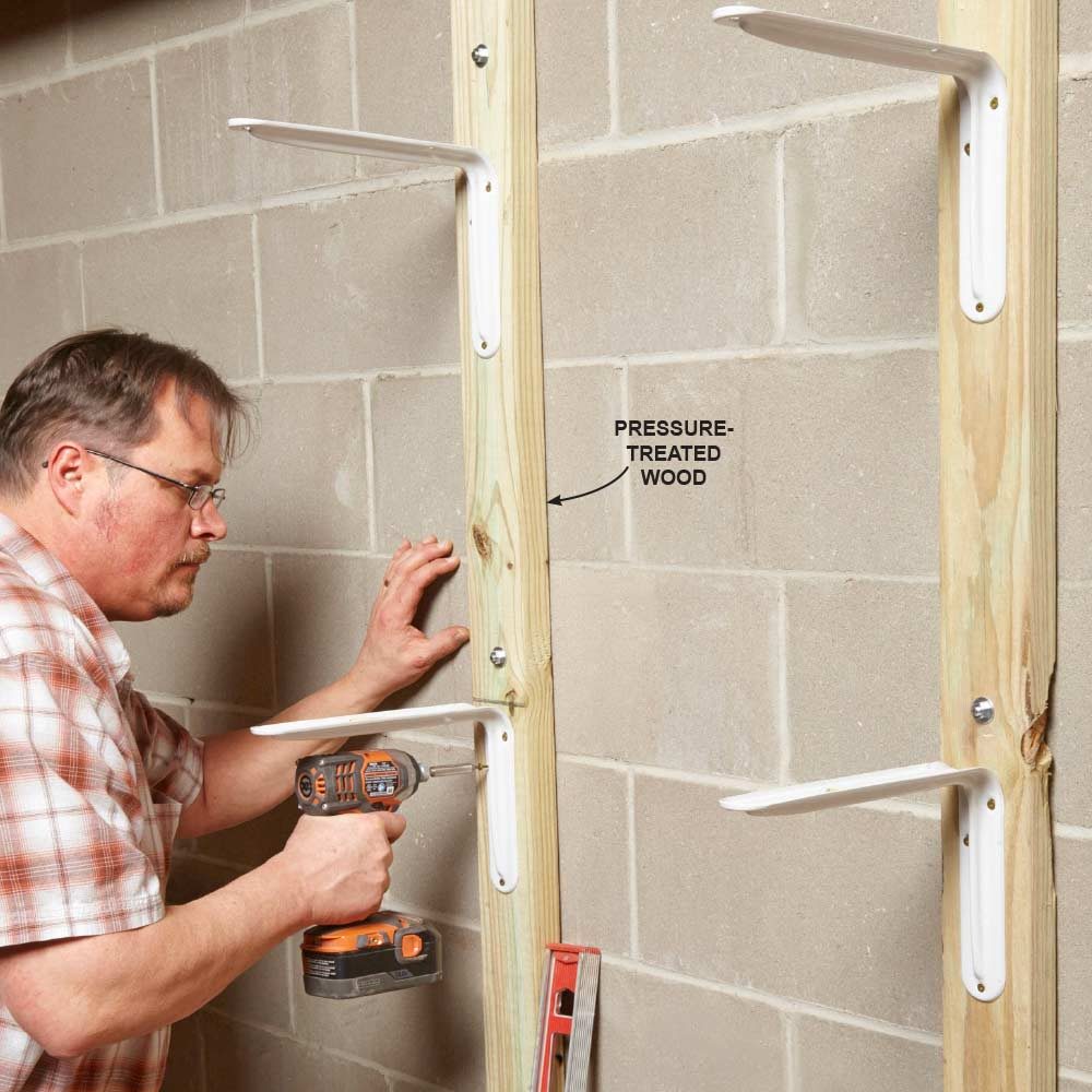 Installing shelf brackets into the screwed-down wood studs | Construction Pro Tips