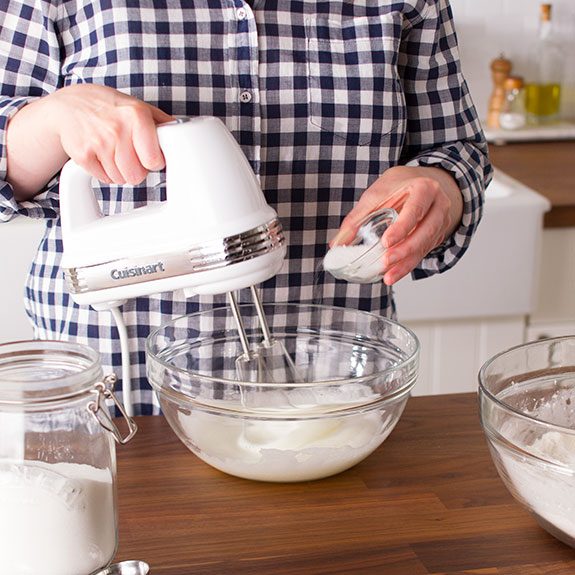 Person using a hand mixer to beat together the dry and wet ingredients